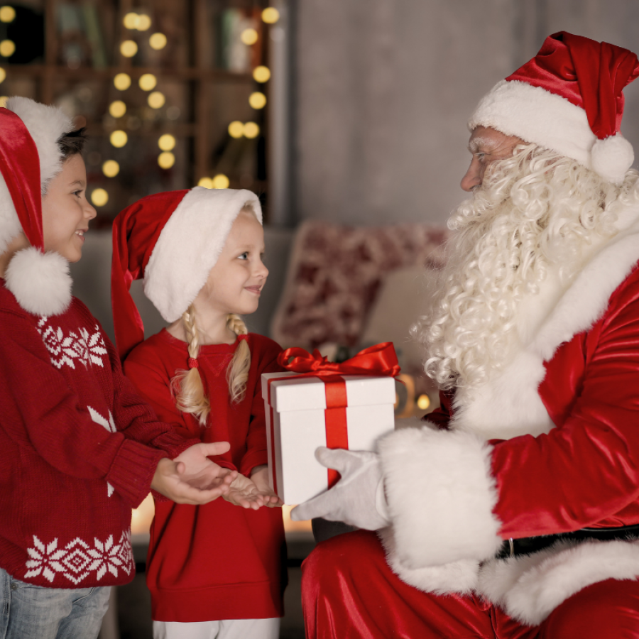 An image of two children meeting Santa Claus