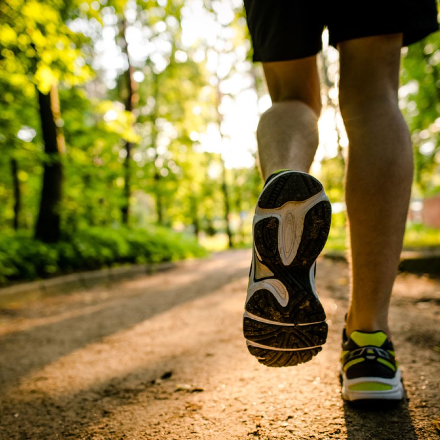 Improve Wellbeing: A person running in the forest