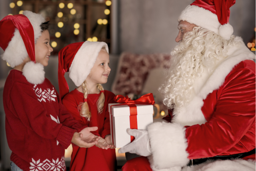 An image of two children meeting Santa Claus